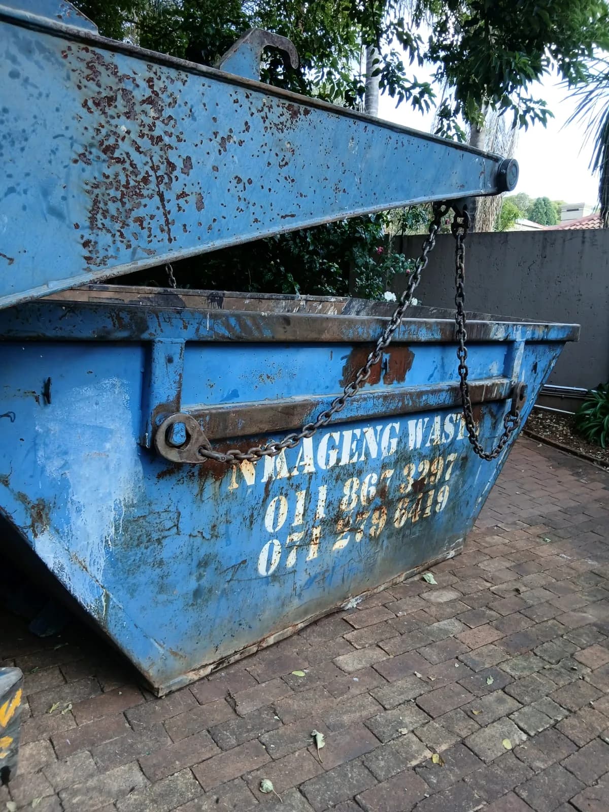 Nkageng Waste skip being dropped at a commercial site