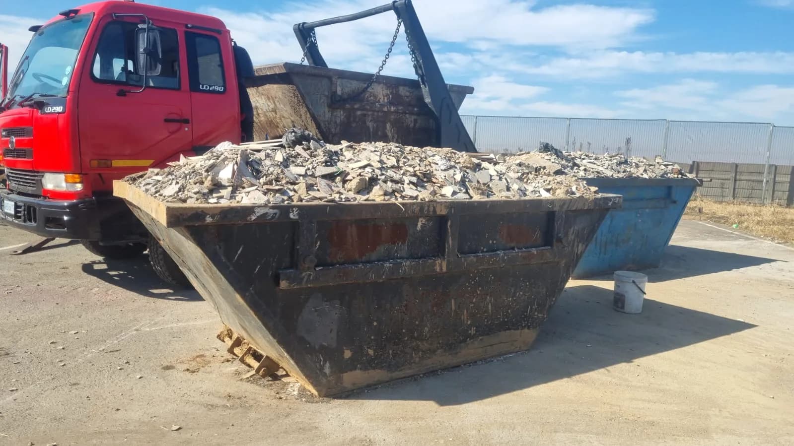 Nkageng Waste 6m³ skip filled with rubble on a skip truck
