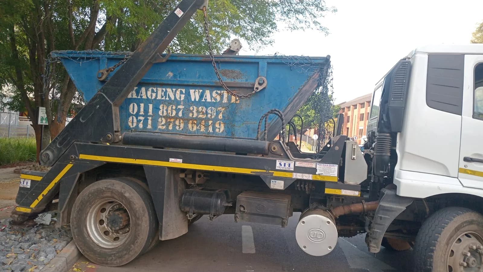 Nkageng Waste skip truck side view with blue skip